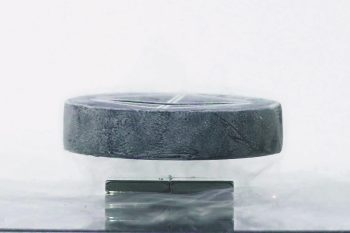 YBCO superconductor disc locked in mid-air above a magnet, in liquid-nitrogen vapour — the Economy Superconductivity Levitation Kit