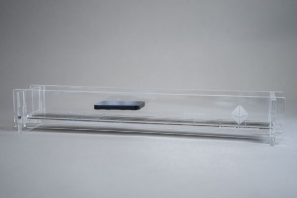 Magnetic train science fair kit: levitating puck above the track in a clear acrylic enclosure